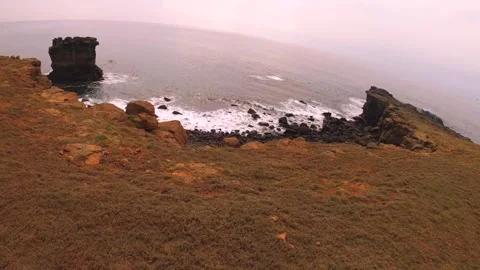 Slow motion of horizontal look out to ocean horizon during gloomy day time at se Stock Footage 243000571
