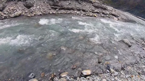 Slow motion horizontal over look to river water surged rapidly with speed raced  Stock Footage 265494343