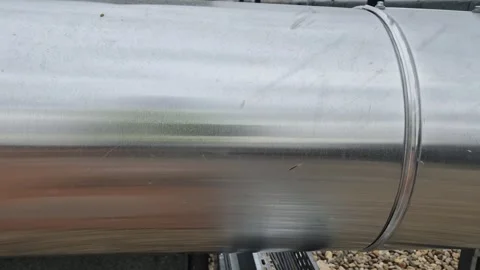 Slow motion horizontal tracking shot of rooftop ventilation duct Stock Footage 334802906