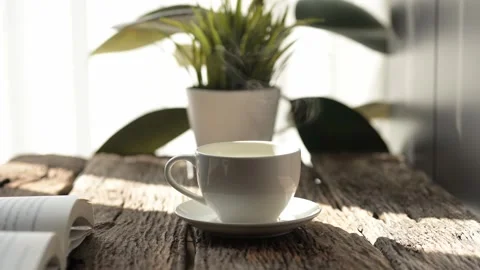 Slow motion hot coffee and espresso mug on rustic table cozy indoor environment Stock Footage 296997889