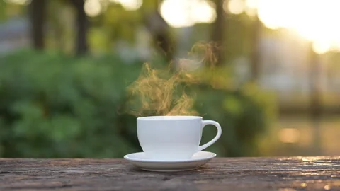 Slow motion hot coffee and espresso mug nature setting warm drink concept Stock Footage 296998899