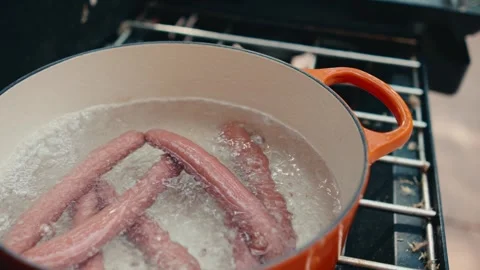 Slow motion hot dogs boiling in water Stock Footage 280330996