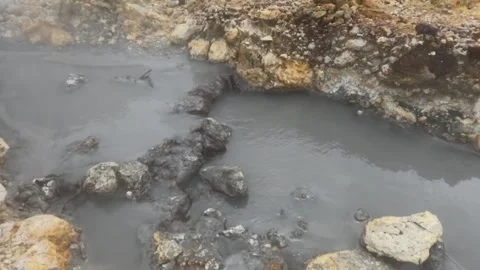 Slow motion of hot mud flow and sulfur steam in the crater area Stock Footage 319908286