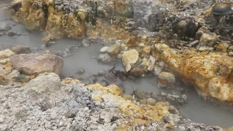 Slow motion of hot mud flow and sulfur steam in the crater area Stock-Footage 319908318