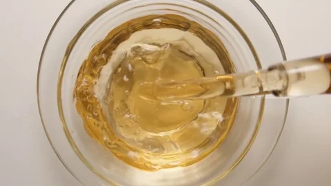 SLOW MOTION: Hot tea flowing to a tea cup from a teapot - top view, close up Video stock 70572700