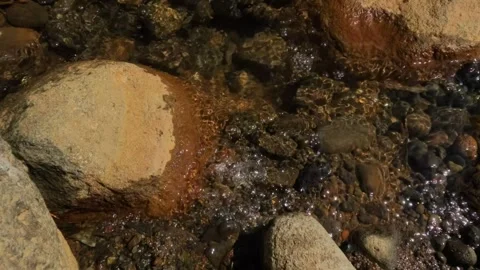 Slow motion hot water bubbles in a rocky river Stock Footage 307432201