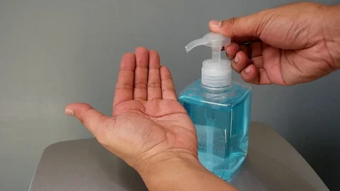 Slow motion of human hand pressing alcohol gel of sanitize hand washing bottle. Stock Footage 126100027