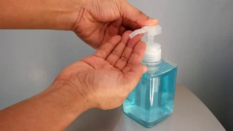 Slow motion of human hand pressing alcohol gel of sanitize hand washing bottle. Stock Footage 126100038