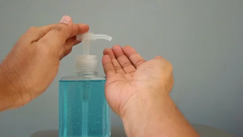 Slow motion of human hand pressing alcohol gel of sanitize hand washing bottle. Stock Footage 126100044