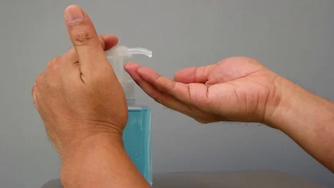 Slow motion of human hand pressing alcohol gel of sanitize hand washing bottle. Stock Footage 126100059
