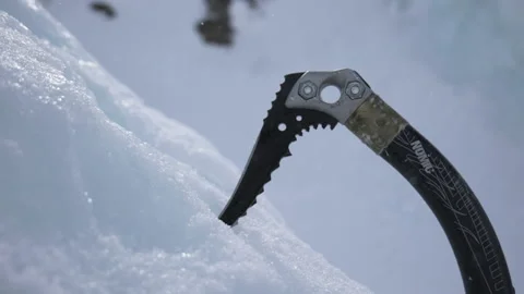 Slow motion of ice axe being hit into ice - outdoor winter sport Stock Footage 237944585