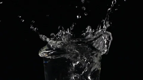 Slow motion ice cube falling down in a glass of water Stock Footage 123199041