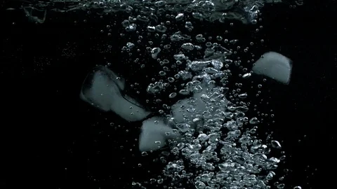 Slow motion of ice cubes falling down and splashing under water Stock Footage 123223025