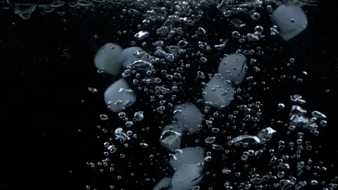 Slow motion of ice cubes falling down and splashing underwater Stock Footage 123223263