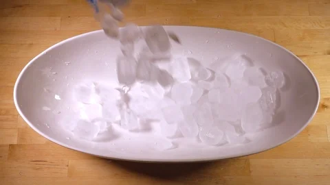 Slow motion - Ice cubes pouring into a bowl. Stock-Footage 113544756