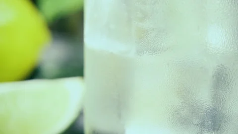 Slow motion ice cubes rotate in a misted glass close-up Stock Footage 92207744