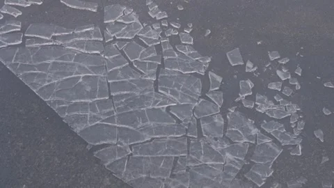 Slow motion of ice shattering breaking on concrete background Stock Footage 248937760