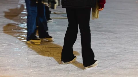 Slow motion ice skating on outdoor rink, close-up of skates Stock Footage 325078231