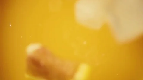 Slow motion iced orange juice falls into Stock Footage 72050371