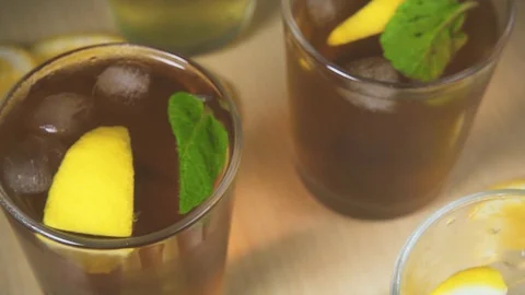 Slow motion iced tea in a glass and movement of the chamber on the flow of water Stock Footage 87756597