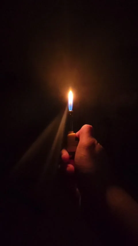 Slow motion ignite fire of gas lighter in a dark Stock Footage 300019528