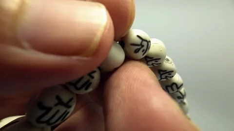 Slow Motion Illustration of Using Prayer Beads for Dhikr Stock Footage 319512800