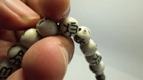 Slow Motion Illustration of Using Prayer Beads for Dhikr Stock Footage 319512813