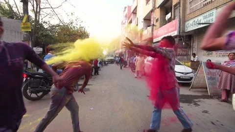Slow-motion image of adults playing at the street of Delhi during Holi festival, Stock Footage 151865429