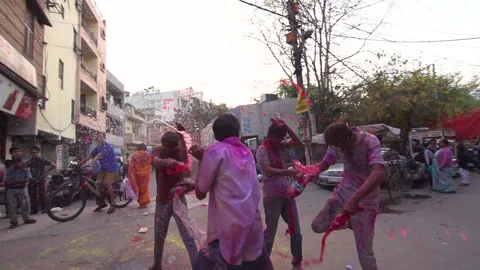 Slow-motion image of adults playing at the street of Delhi during Holi festival, Stock Footage 151865754