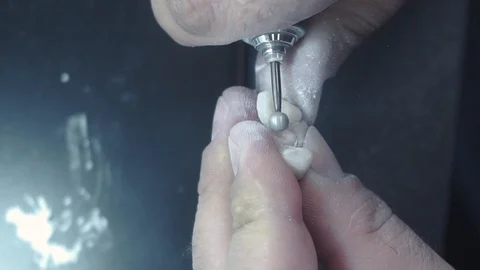 Slow motion image of the prosthetist who grinds  teethat laboratory close up Stock Footage 127896436