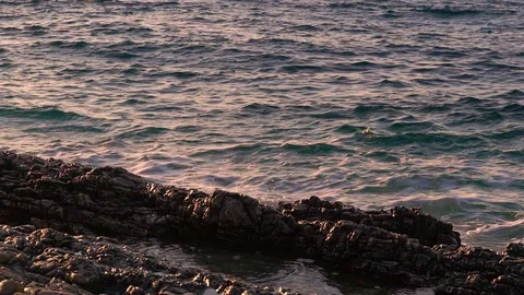 Slow motion image of seawater breaking at shore during a scenic sunset, Croatia. Stock-Footage 114685010