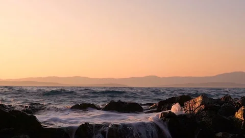 Slow motion image of seawater breaking at shore during a scenic sunset, Croatia. Video stock 114685619