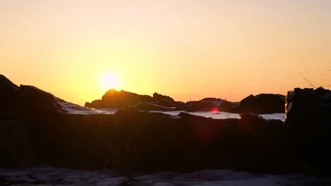 Slow motion image of seawater breaking at shore during a scenic sunset, Croatia. Video stock 114685670
