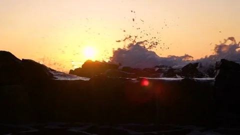 Slow motion image of seawater breaking at shore during a scenic sunset, Croatia. Stock Footage 114685682