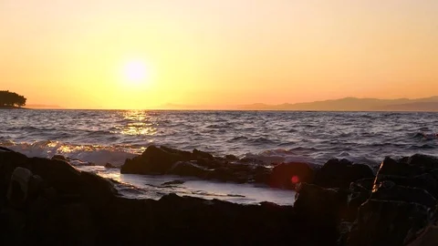 Slow motion image of seawater breaking at shore during a scenic sunset, Croatia. Stock Footage 114685891