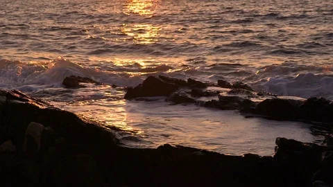 Slow motion image of seawater breaking at shore during a scenic sunset, Croatia. Stock Footage 114686185