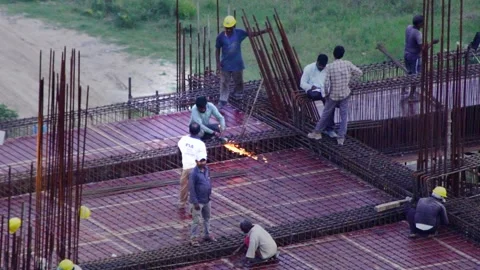 Slow motion indian construction workers standing on a rebar covered roof while Video stock 161178452