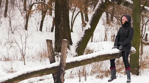 Slow Motion, Indian Guy and Beautiful Woman Ride on a Swing in the Winter Forest Stock Footage 101406198