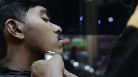 Slow motion indian man being shaved Stock Footage 59999244