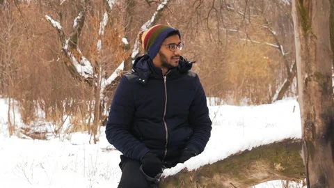 Slow Motion, Indian Man in Glasses Rides on a Wooden Swing in  Winter in  Forest Stock Footage 101408017