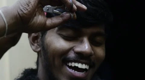 Slow motion indian man smiling while getting  haircut Stock Footage 60042298
