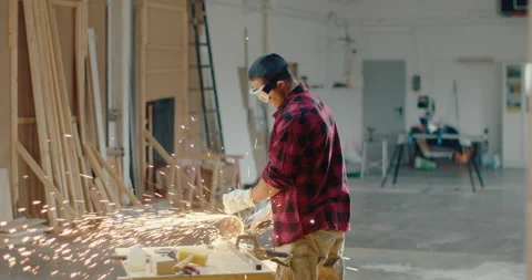 Slow motion of an industrial engineer working on cutting metal and steel with an Stock Footage 199614987