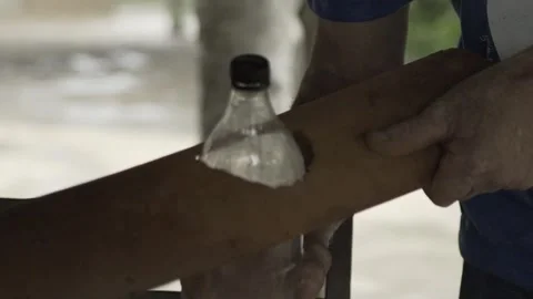 Slow Motion Installation of Moser Lamp Solar Bottle Light on Roof Tile Stock Footage 320571364