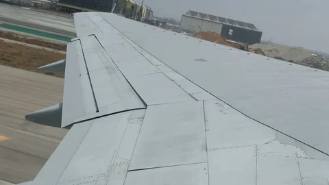 Slow Motion Interior Plane Wing View Take Off from LAX Stock Footage 91346109
