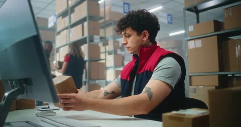 Slow motion of inventory manager scanning parcel, preparing for shipping Stock Footage 307557502