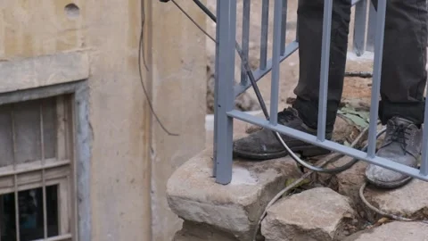 Slow motion ironing buttom corner of balcony steel Stock Footage 232382493