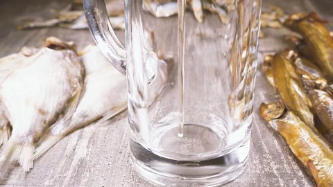 Slow motion it is beautiful to pour beer in a mug near salted fish Stock Footage 94122670