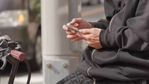 Slow motion of Japanese man using phone on bicycle in Osaka Stock Footage 336637883
