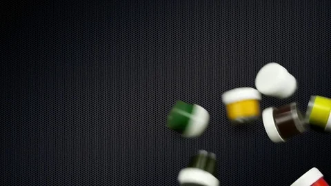 Slow motion jars of paint fall on smooth background of metallic dark gray grid. 库存影片 84498805