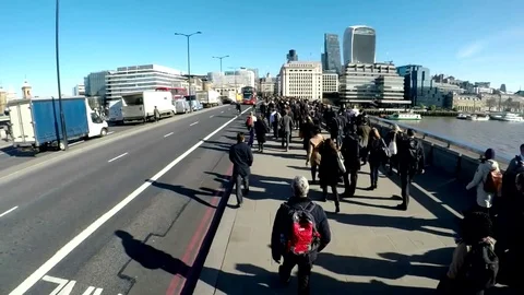 Slow motion jib shot of commuters crossing London Bridge - clip 11 動画素材 75736421